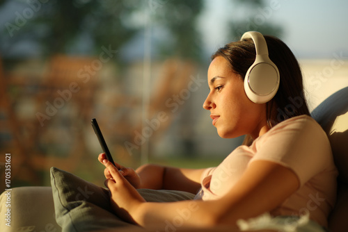 Serious woman is listening audio checking mobile phone