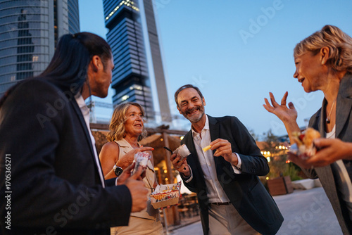 Businesspeople enjoying street food after work in Madrid