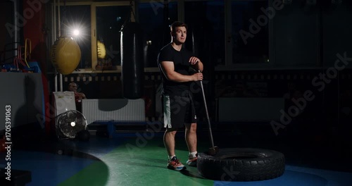 In a dim boxing ring, a determined man showcases his skills in an intense match