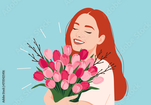 Joyful young woman admiring a beautiful bouquet of pink and red tulips on a light blue background