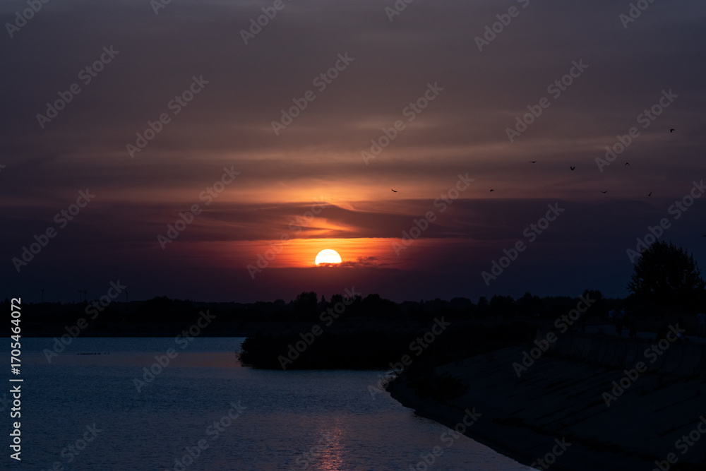 Naklejka premium sunset over the river