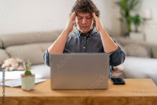Frustrated Man Facing Laptop in a Domestic Setting