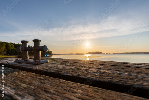 Amazing golden sunset from Ruissalo island over the Turku archipelago in south west Finland with a view on a swimming jetty which are everywhere on the many islands for locals to enjoy the Baltic sea 