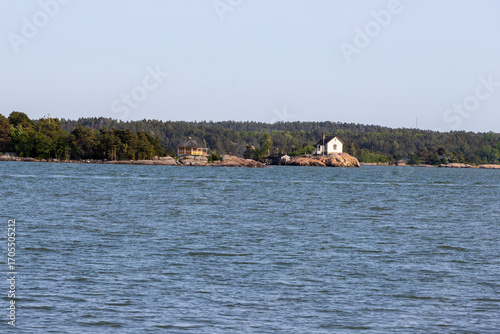 View over the archipelago near the city of Turku with a view on one of the islands with its typical Scandinavian wooden houses and a small harbour for leisure water activities
