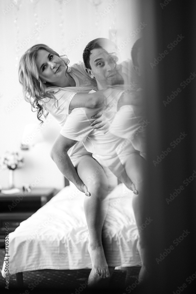 Fototapeta premium young couple bride and groom in the morning in a hotel room