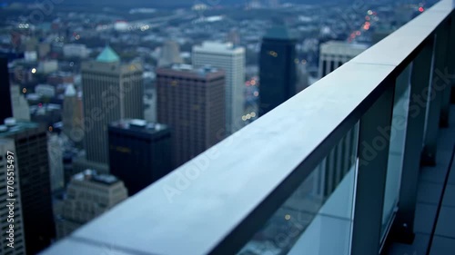View of city skyline from rooftop balcony with glass railing at dusk, cityscape, architecture, and urban landscape
