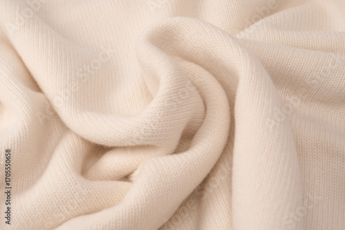 Soft milky color merino wool sweater texture as a background.