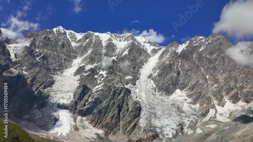 Majestic view of the Shkhara Glacier in the Caucasus Mountains, Georgia, showcasing its icy slopes and the surrounding peaks