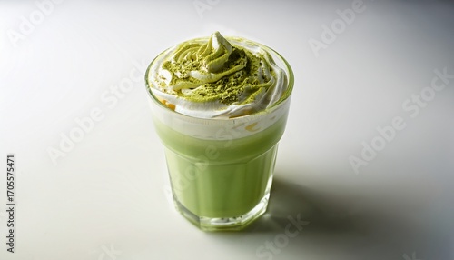 Freshly Prepared Matcha Frappuccino Adorned With Whipped Cream And Sprinkled Green Tea Powder Sits In A Clear Cup On A Bright White Background Lit By Soft Natural Light