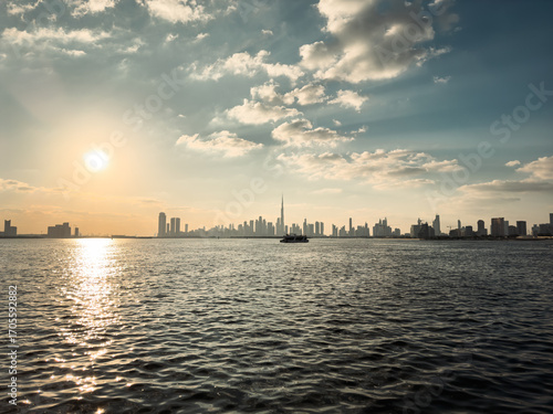 Photography Dubai skyline panoramic view at sunset with waterfront, boats on the horizon, an