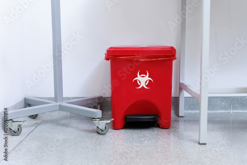 Fotografie Medical waste disposal room with red biohazard containers and bins