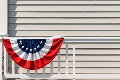patriotic american flag bunting hanging on white residential railing during sunny summer day