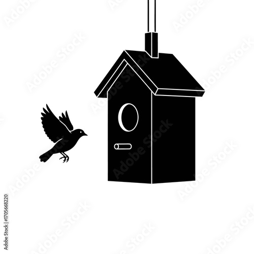 Silhouette of a bird flying towards a birdhouse