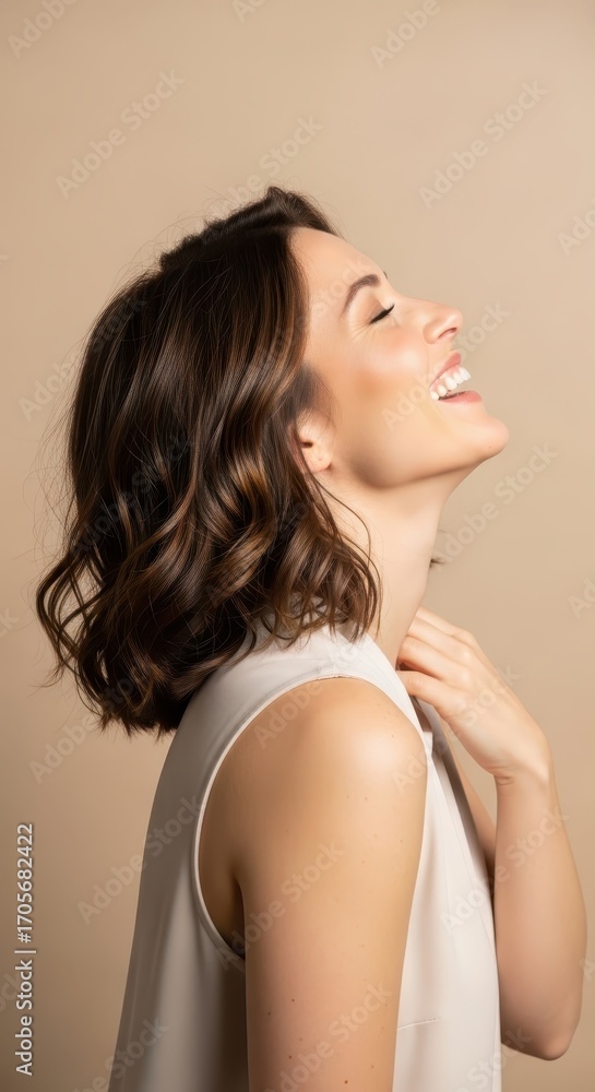 Naklejka premium A beautiful woman with short brown hair laughs with her head tilted back and eyes closed, conveying joy and happiness