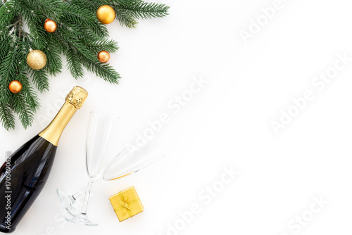 Christmas bottle of champagne with two glasses and fir tree branches, top view. Happy New Year and Merry Christmas decoration
