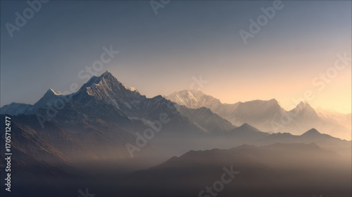 Majestic mountain peaks layered in misty blue haze at sunrise, dramatic Himalayan ridge silhouettes with atmospheric fog, epic alpine landscape panorama with golden sunlight horizon