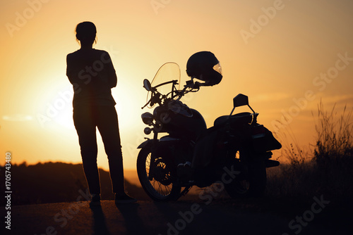 Woman and her motorbike in beautiful sunset light.
