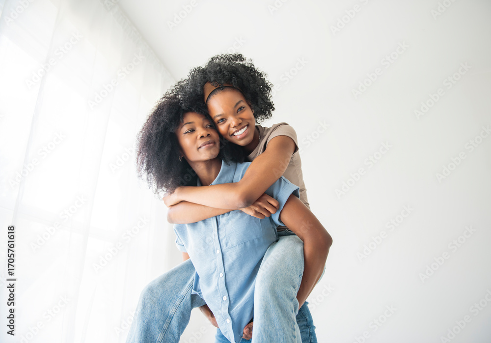 Obraz premium Affectionate mother and daughter portrait close to a white wall