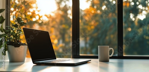 Sunlit Workspace With Laptop, Coffee Cup, and Potted Plant in a Cozy Indoor S...