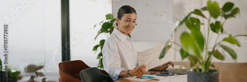 A professional woman engaged in her work in a modern office designed for productivity