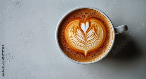 Creamy Latte Art Displayed in a White Cup on a Textured Surface in a Cozy Cafe.