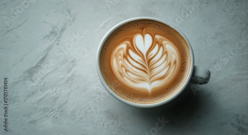Creamy Latte Art Displayed in a White Cup on a Textured Surface in a Cozy Cafe