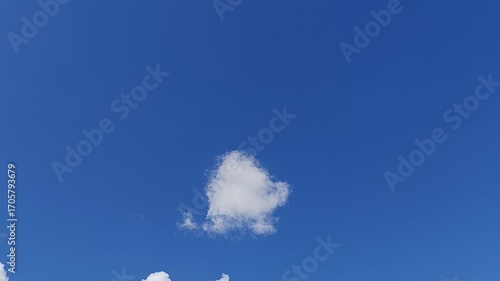 Time lapse cloudscape video. Blue sky with several layers of clouds. Slow moving white cumulus cloud. Timelapse of the clear sky. White clouds running over blue sky. Cloudy sky, ozone layer. 