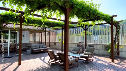 Outdoor patio area under a wooden pergola with lush greenery, comfortable seating, and a view