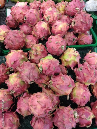 piles of dragon fruit in supermarket display baskets, a bunch of dragon fruit sold in stores, fresh dragon fruit in store baskets