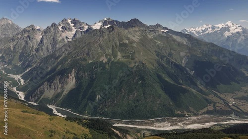 Majestic Snow Capped Mount Shkhara Dominates the Landscape of the Caucasus Mountains in Georgia, Creating a Breathtaking View Against a Vibrant Blue Sky
