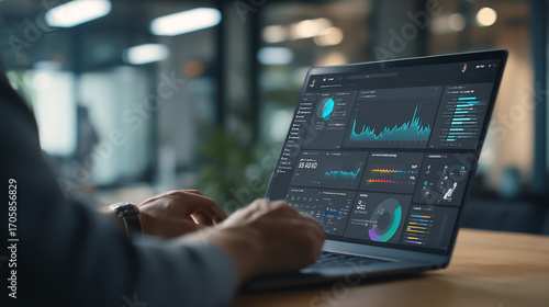 Professional marketer analyzing target customer data on laptop computer, using charts and graphs for marketing segmentation strategy and personalized campaigns