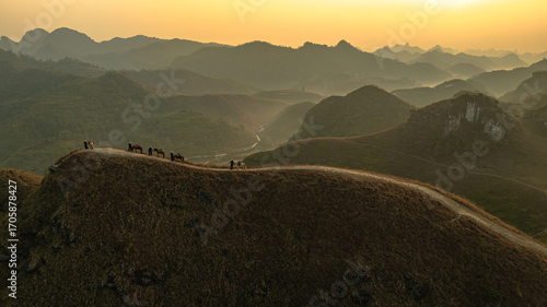 Foto Dawn on the high mountain peaks of Ha Lang area, with pack horses and people going to work