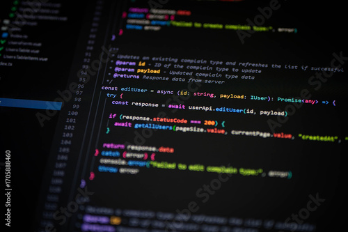 Photography Close-up of TypeScript code editing user data with async functions on a dark IDE
