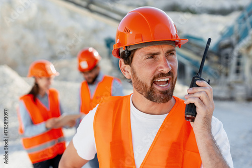 Tableau sur toile Construction worker communicating using walkie talkie in quarry