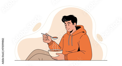 Enjoying Warm Meal: Smiling Man in Hoodie Tasting Soup from a Spoon for Mealtime Pleasure