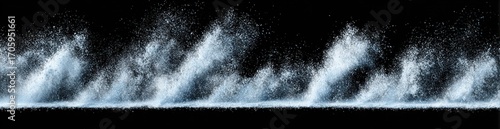 Row of water plumes erupting upwards against a black background, creating a dynamic and slightly ominous atmosphere