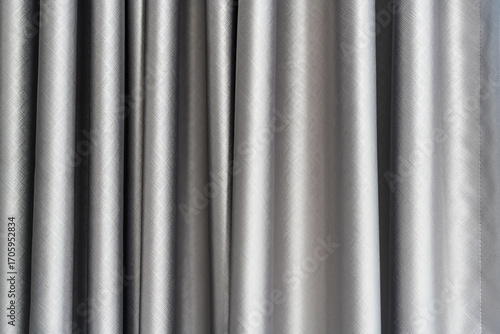 Minimalist curtains gentle light grey background for product presentation with light and shadow of window curtains on wall.