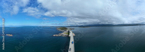 Slika na platnu Spectacular landscape showcases the winding Atlantic Ocean Road in Norway, surrounded by tranquil waters and lush greenery
