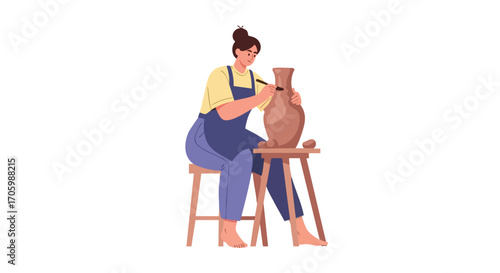 A barefoot woman potter in a blue apron sitting on a stool and sculpting a clay vase with a tool.