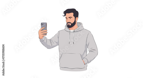 A bearded man in a grey hoodie taking a selfie with his smartphone.