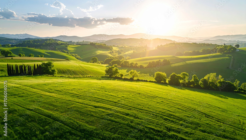 Obraz premium Aerial View of Green Fields and Hills at Sunset