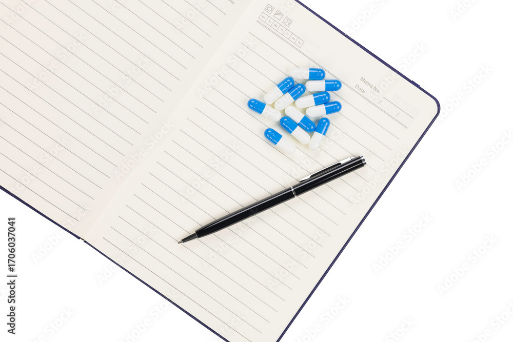 Naklejka premium Medicine capsules on notebook with pen for pharmaceutical research and laboratory documentation