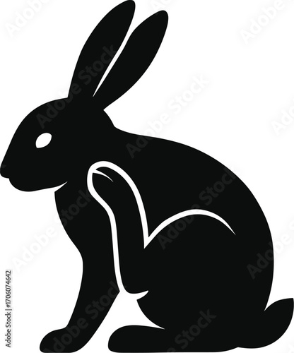 Minimal vector silhouette, rabbit ear-scratch with hind leg, seated side view, solid black