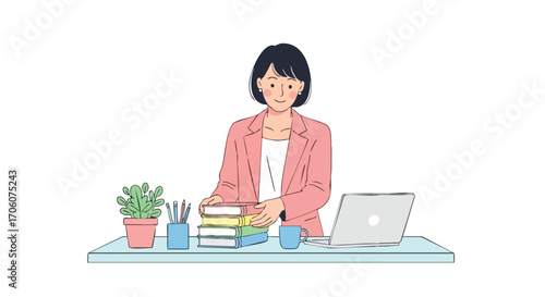 Smiling professional woman in a pink blazer stacking books on her office desk with a laptop.