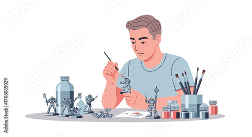 Young man engaged in the hobby of painting miniature scifi soldier figures at a table.