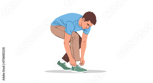 Young man in a blue shirt and brown pants bending down to tie the laces on his green sneakers.