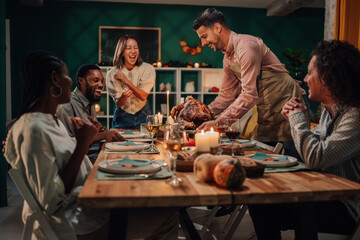 Friends celebrating thanksgiving enjoying roasted turkey together