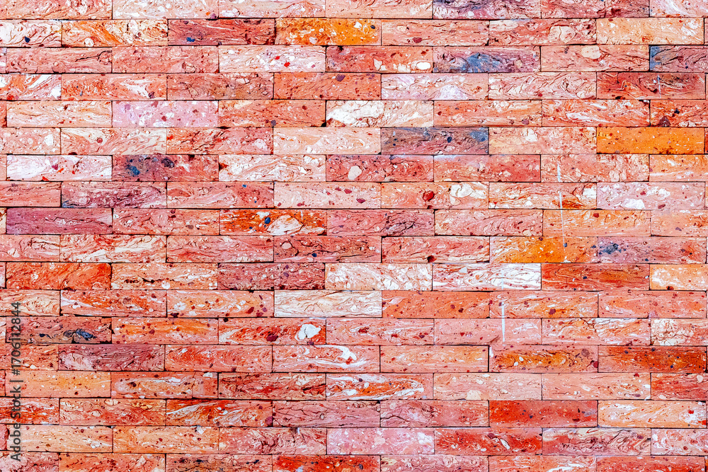 Red and pink brick wall with varied patterns and textures