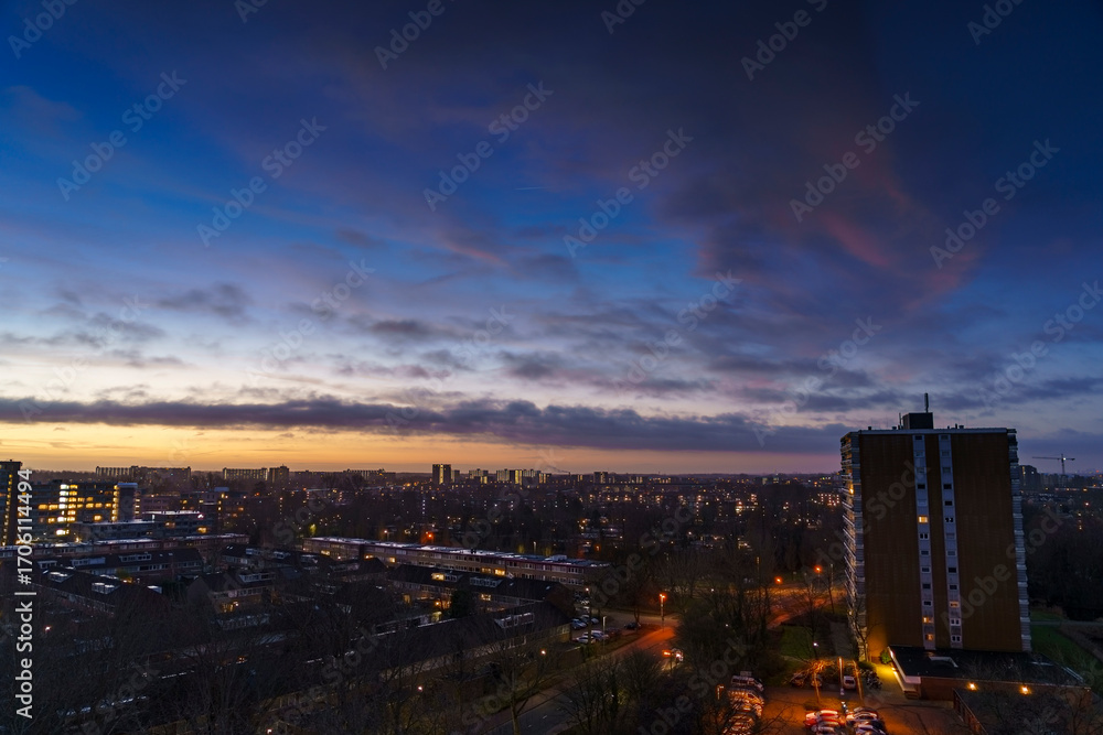 Obraz premium Breathtaking balcony view overlooking the lush green fields of Holland's countryside during a stormy summer sunset near Amsterdam, Netherlands