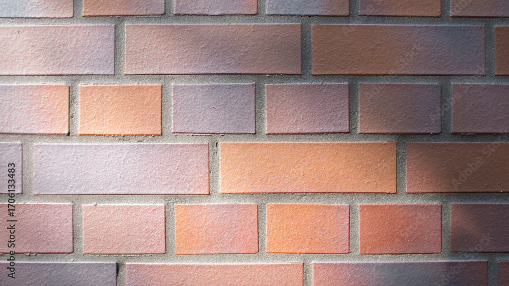 Obraz premium Wall of rectangular orange-coloured bricks